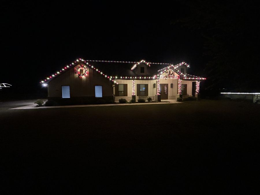 Home with classic red and white Christmas lights and wreaths